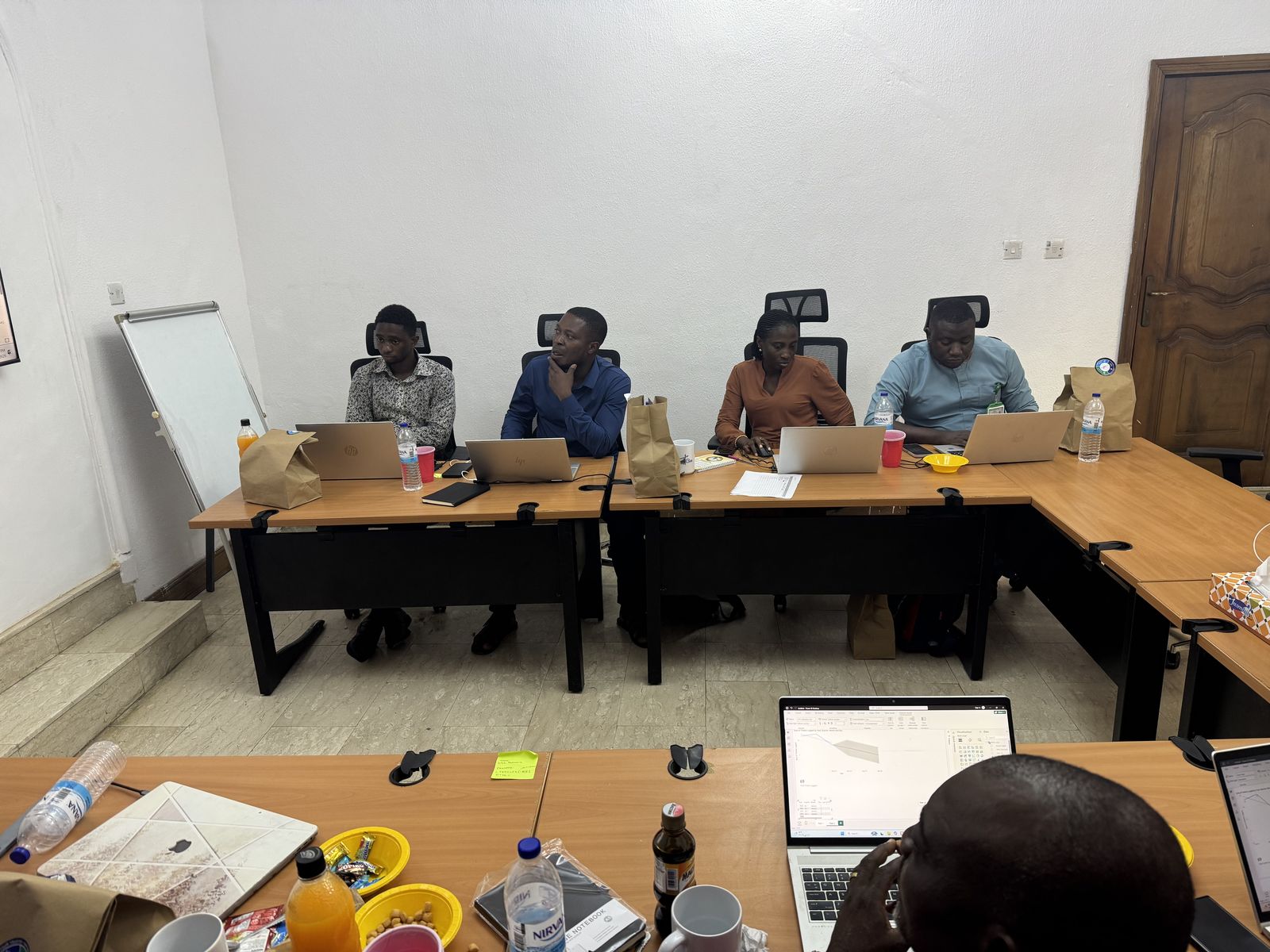 PixelAnchor live training room — professionals working on laptops